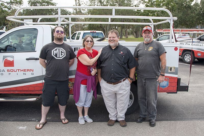 Iraq War Veteran and 2019 Roofs for Heroes recipient Roy Bostic with Brian Wallace, President of Florida Southern Roofing and others.